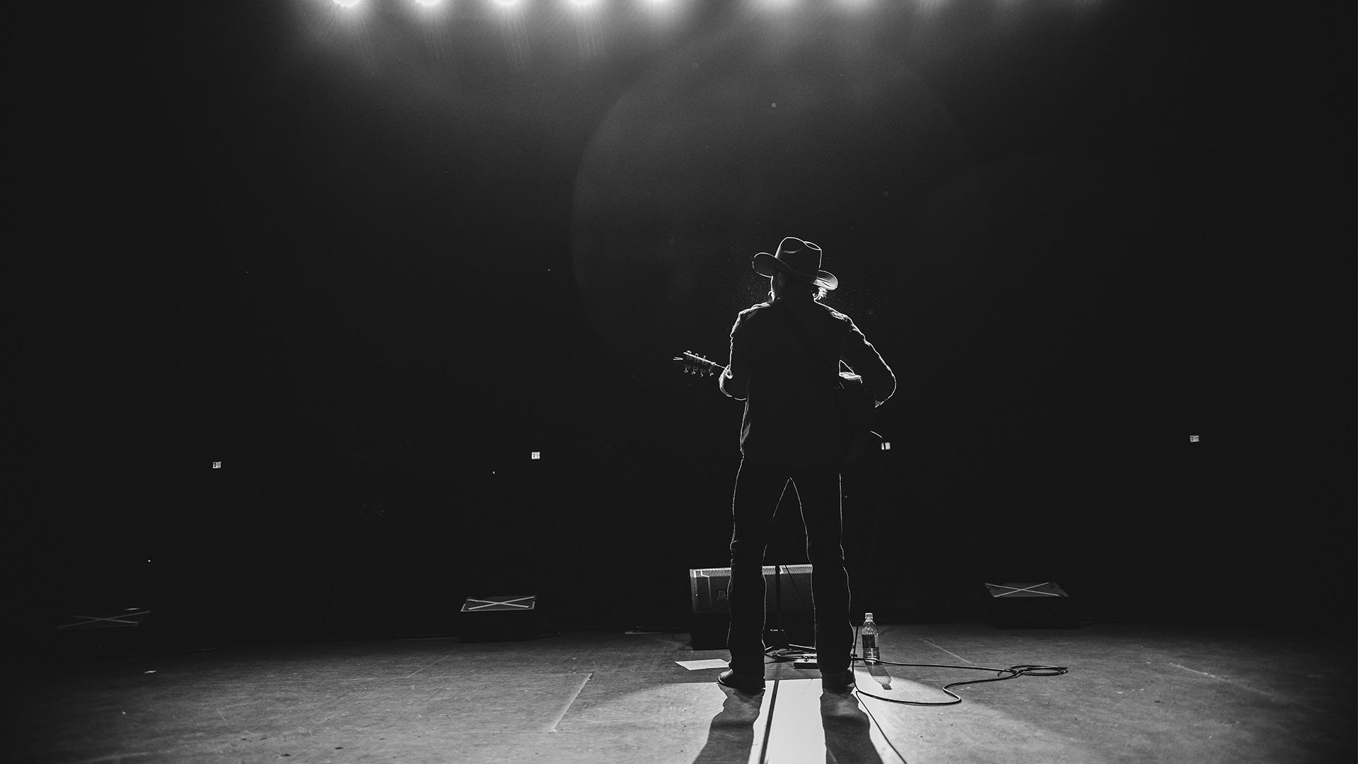 Will Jones silhouetted on stage